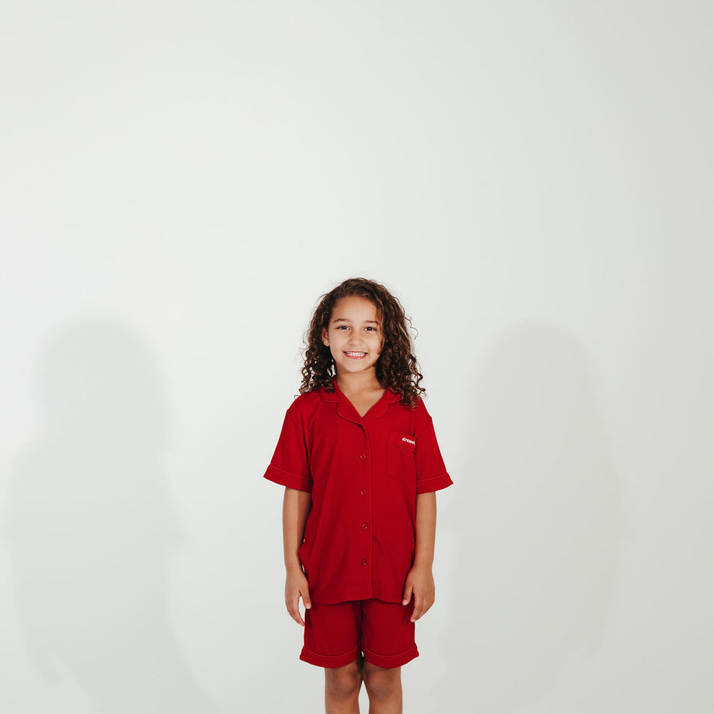 Child wearing a red outfit on a white background