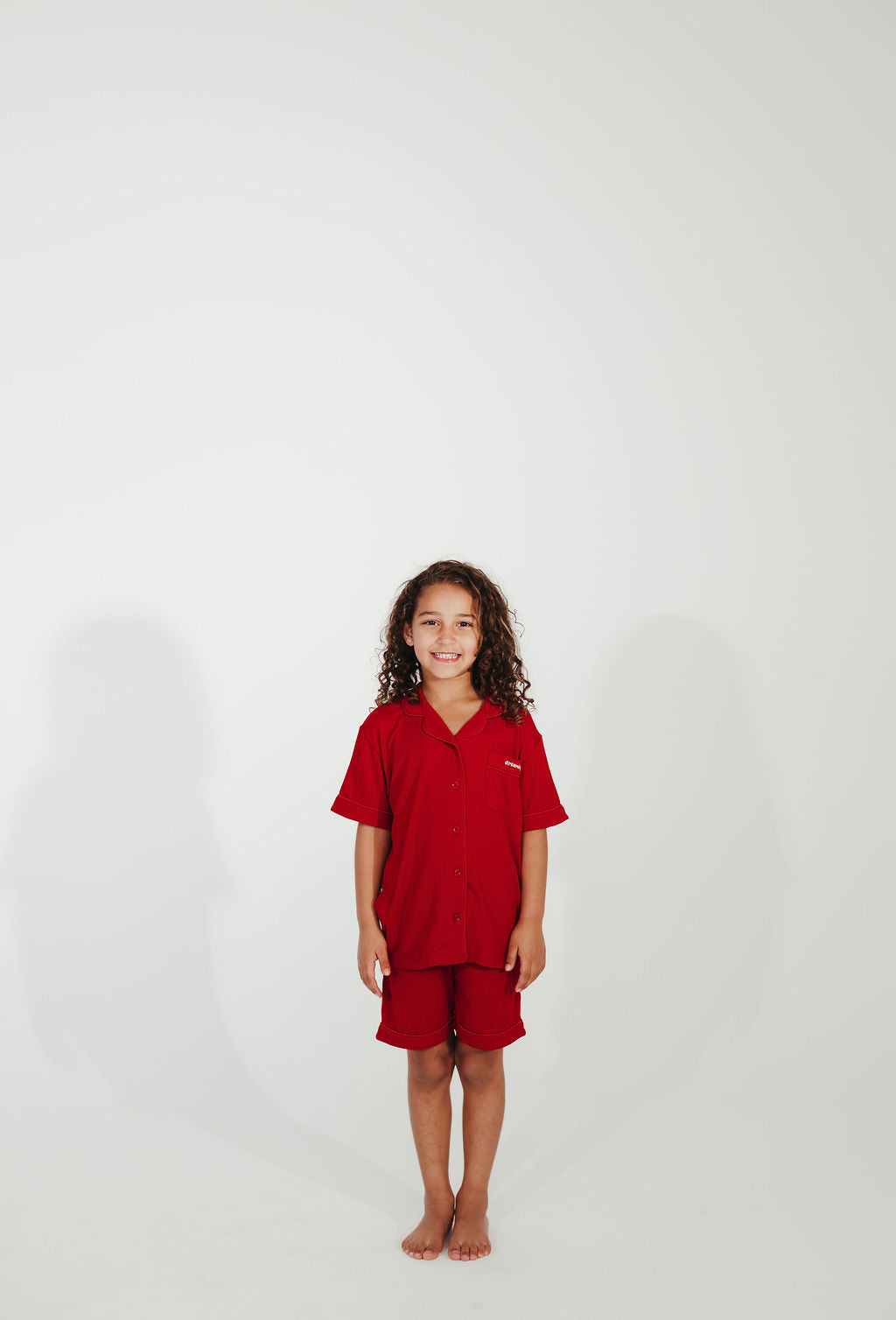 Child wearing a red outfit on a white background